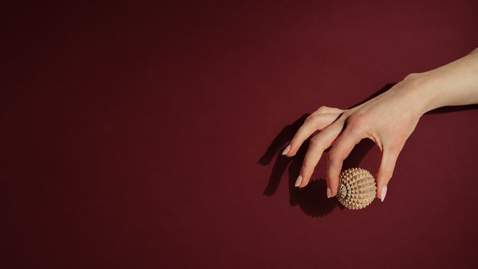 hand holding calm companion handcarved wooden acupressure ball